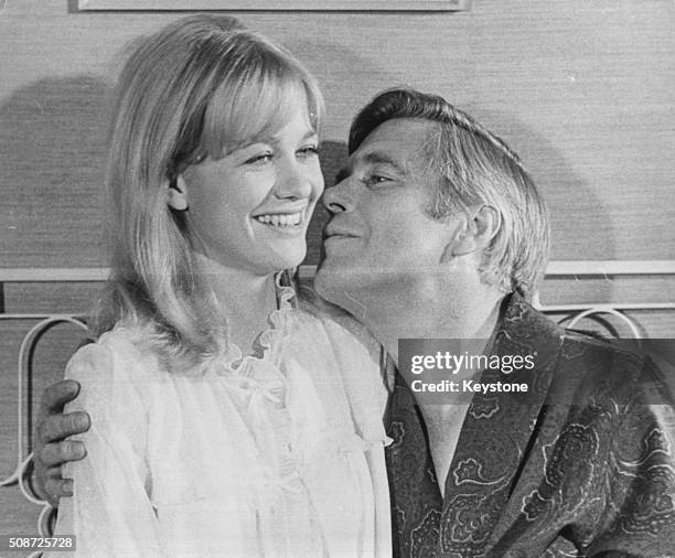 Actor George Peppard kissing actress Judy Geeson in bed as they film a scene from the film 'The Executioner', London, April 8th 1969.