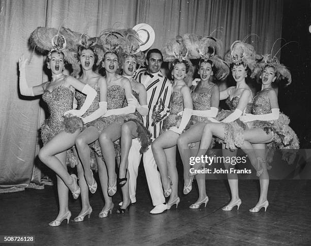 Actor Tyrone Power posing with a row of chorus girls Peggy Cummins, Anne Massey, Sheila Sim, Joan Sims, Jean Kent, Thelma Ruby, Dulcie Grey and...