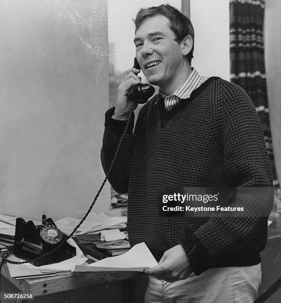 Songwriter Mike Pratt, composer of the new musical 'The Big Client' at the Bristol Old Vic, pictured making a phone call, circa 1961.