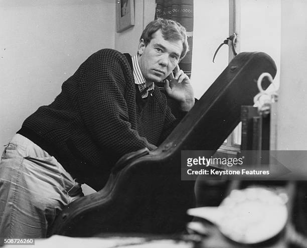 Songwriter Mike Pratt, composer of the new musical 'The Big Client' at the Bristol Old Vic, pictured with his guitar, circa 1961.