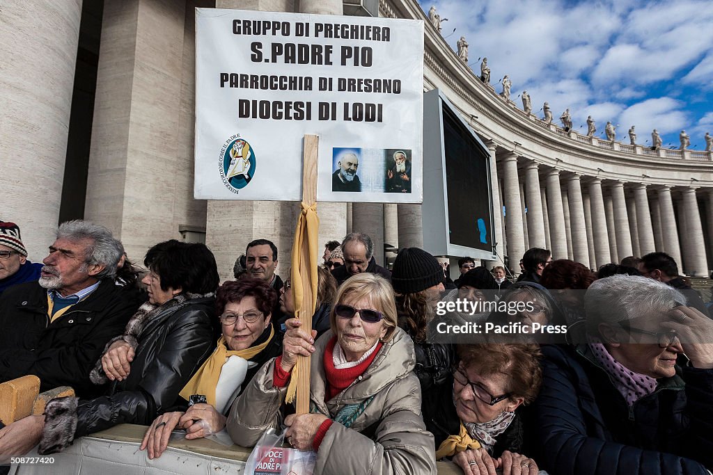 Faithful gather in St. Peter's Square before the arrival of...