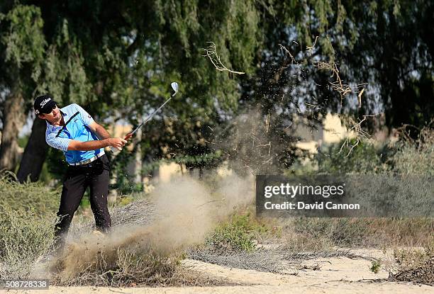 Gary Stal of France plays his second shot at the par 4, 14th hole during the third round of the 2016 Omega Dubai Desert Classic on the Majlis Course...