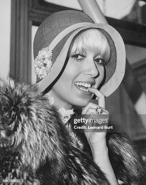 Actress Adrienne Posta pictured preparing to fly to Los Angeles to start work in the television show 'Lampoon', at London Airport, May 1st 1974.