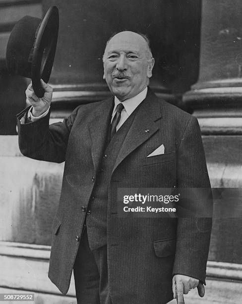 French diplomat Francois Charles-Roux, President of the Suez Canal Company, doffing his hat as he leaves at 10 Downing Street following a meeting...