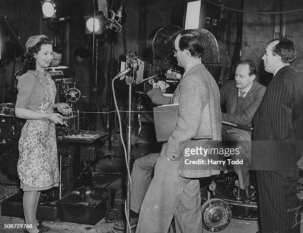 Actress Patricia Roc talking to directors Frank Launder and Sidney Gilliat on the set of the film 'Millions Like Us' at Gaumont-British Studios,...
