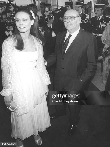 Film director Roberto Rossellini and actress Marthe Keller, both members of the jury at the Cannes Film Festival, arriving at the film competition,...