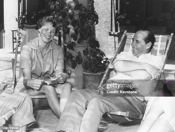 Film director Roberto Rossellini and his wife, actress Ingrid Bergman, relaxing together in deck chairs, in Portofino, circa 1952. Printed following...