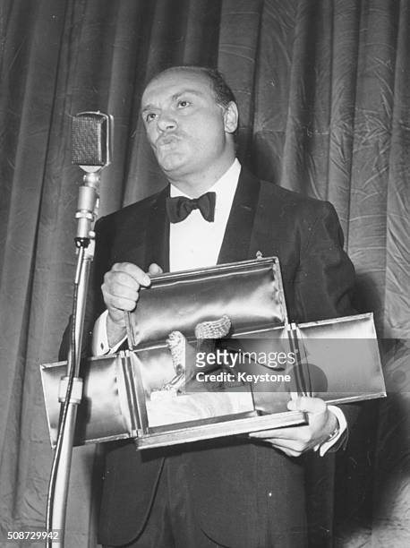Italian film director Francesco Rosi holding his Golden Lion award for the film 'Hands Over the City', on stage at the Venice Film Festival, Italy,...