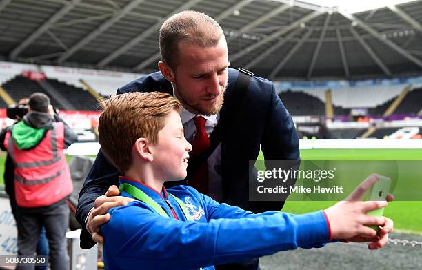 Brede Hangeland of Crystal Palace poses for photographs for a young Crystal Palace supporter prior to the Barclays Premier League match between...