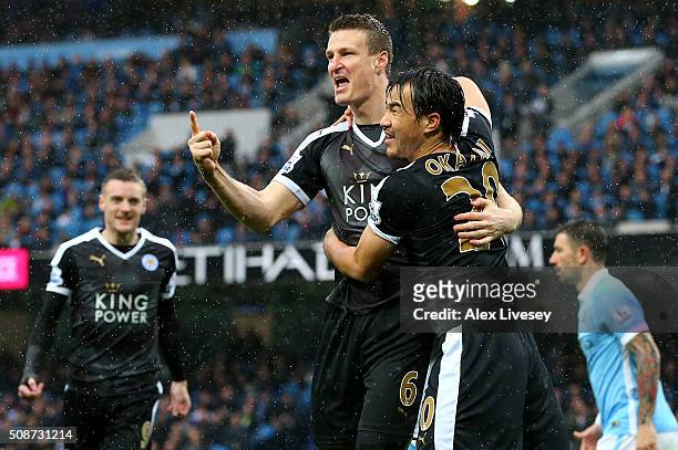 Robert Huth of Leicester City celebrates scoring his team's first goal with his team mate Shinji Okazaki during the Barclays Premier League match...