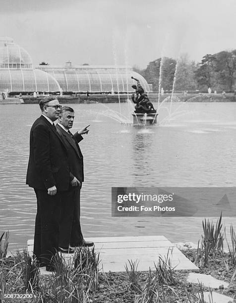 Geoffrey Rippon , Minister for Public Buildings and Works, walking near the lake with Sir George Taylor, the Director of the Botanical Gardens, as...