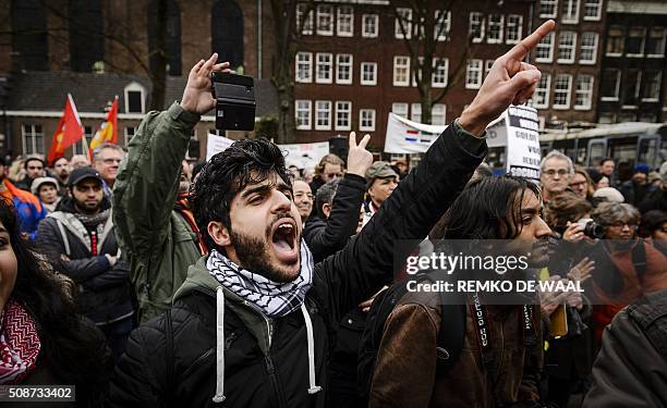 Opponents of anti-Islamic political movement PEGIDA protest and shout slogans prior to a demonstration of the anti-immigrant PEGIDA movement in...