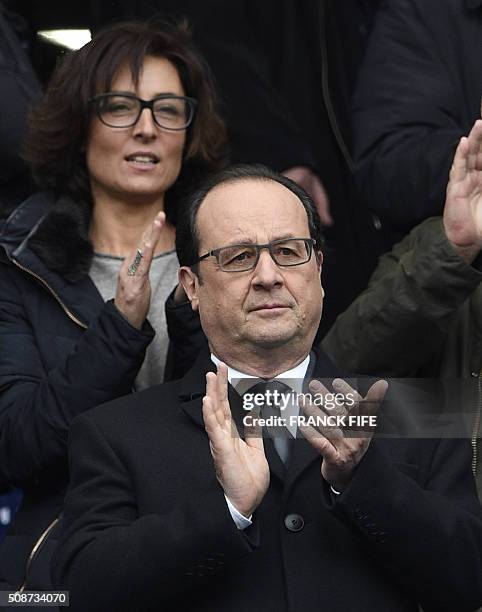 French President Francois Hollande and his councillor for sports Nathalie Iannetta attend the Six Nations international rugby union match between...