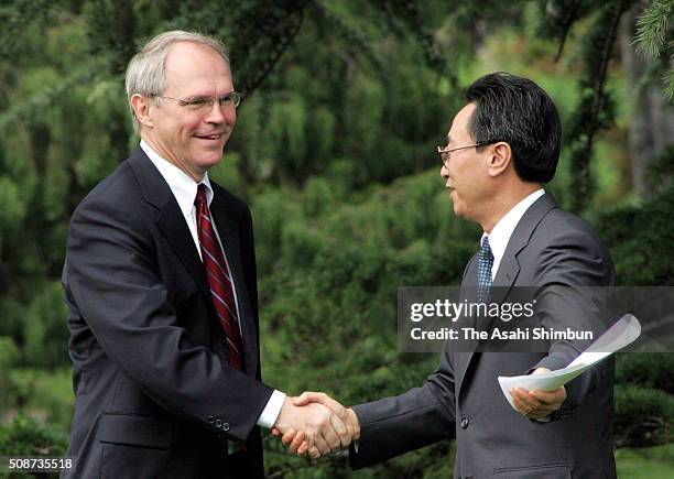 Wu Dawei , Vice Foreign Minister of China and U.S. Assistant Secretary of State Christopher Hill shake hands after a press conference after the six...