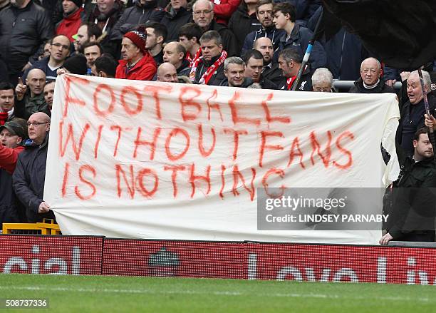 Liverpool fans hold a banner as they protest against the recently announced rise in ticket prices during the English Premier League football match...