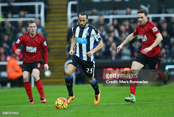 Andros Townsend of Newcastle United is tracked by James Chester and Craig Gardner of West Bromwich Albion during the Barclays Premier League match...