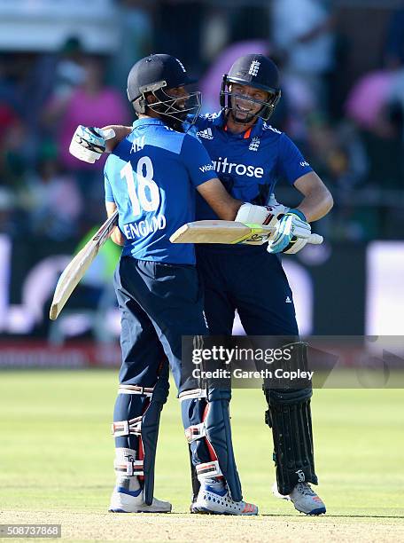 Jos Buttler and Moeen Ali of England celebrate winning the 2nd Momentum ODI between South Africa and England at St George's Park on February 6, 2016...