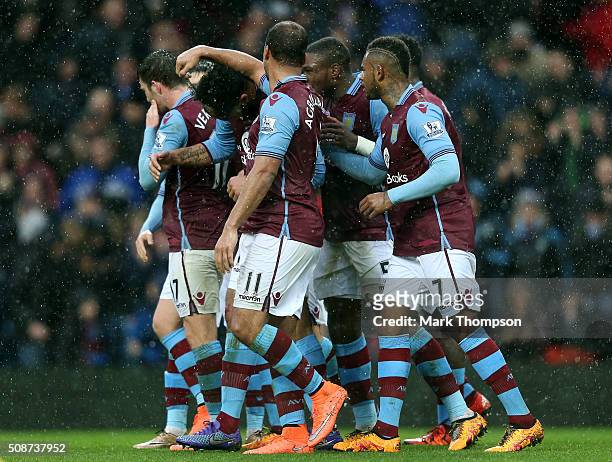 Joleon Lescott of Aston Villa celebrates scoring his team's first goal with his team mates during the Barclays Premier League match between Aston...