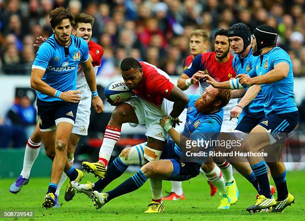 Virimi Vakatawa of France breaks free from a tackle by Gonzalo Garcia of Italy during the RBS Six Nations match between France and Italy at Stade de...