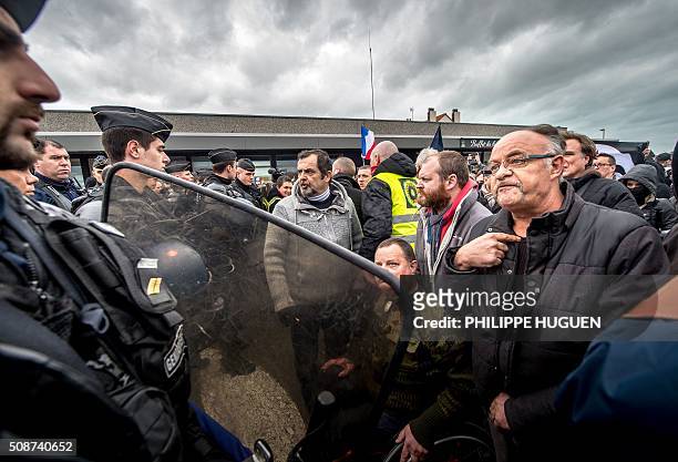 Policemen disperse supporters of the Pegida movement during a demonstration in Calais, northern France on February 6, 2016. Anti-migrant protesters...
