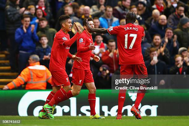 Roberto Firmino of Liverpool celebrates scoring his team's first goal with his team mates Adam Lallana and Mamadou Sakho during the Barclays Premier...