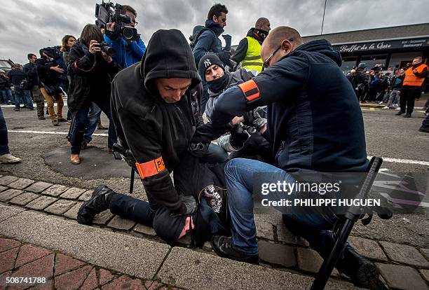 Policemen arrest a supporter of the Pegida movement during a demonstration in Calais, northern France on February 6, 2016. Anti-migrant protesters in...