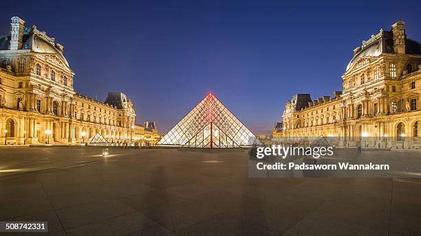 The front view of Louvre museum at dusk