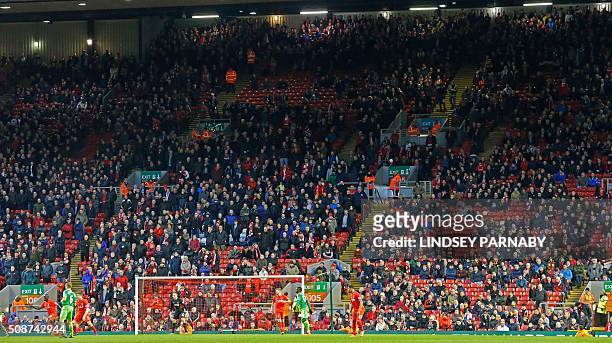 Liverpool fans leave the stands at the Kop End after 77 minutes' of play during the English Premier League football match between Liverpool and...