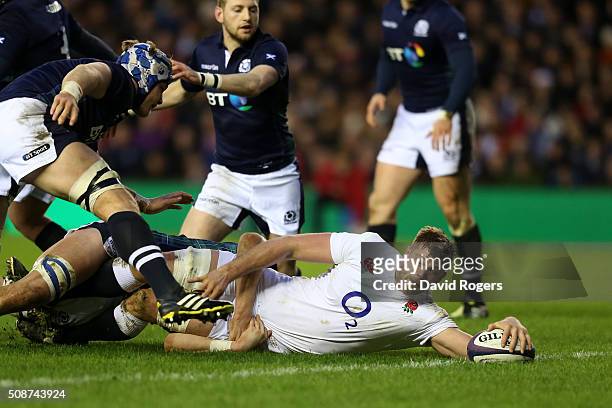 Lock George Kruis of England crashes over to score the opening try during the RBS Six Nations match between Scotland and England at Murrayfield...