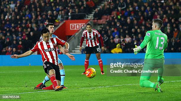 Maya Yoshida of Southampton shoots past Adrian of West Ham United to score their first goal during the Barclays Premier League match between...