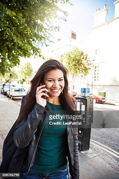 beautiful woman portrait having a call on the street - the 2016 notting hill carnival stock pictures, royalty-free photos & images