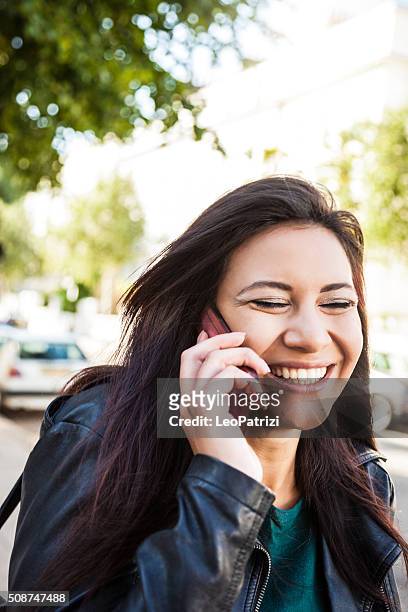 beautiful woman portrait having a call on the street - the 2016 notting hill carnival stock pictures, royalty-free photos & images