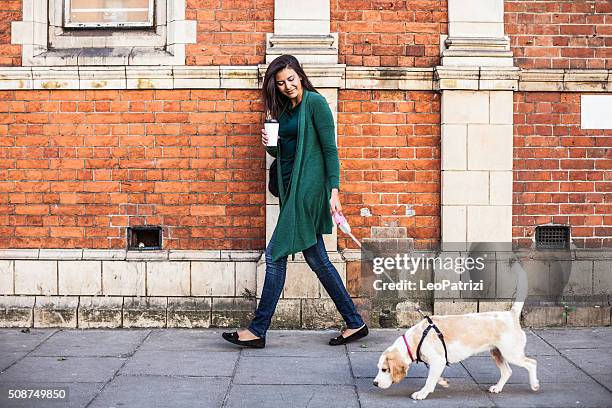 woman walking with dog in early sunday morning in london - coffee city stock pictures, royalty-free photos & images