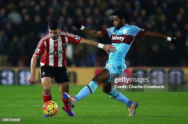 Shane Long of Southampton holds off Alexandre Song of West Ham United during the Barclays Premier League match between Southampton and West Ham...