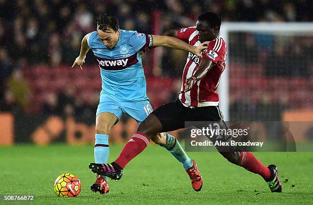 Mark Noble of West Ham United holds off Victor Wanyama of Southampton during the Barclays Premier League match between Southampton and West Ham...