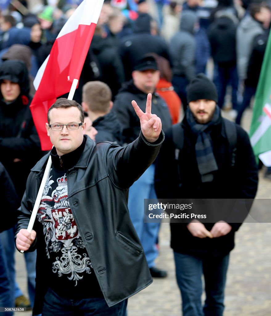 A  man flashes the peace sign during a demonstration against...