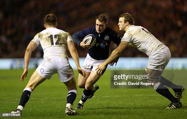 Stuart Hogg of Scotland is tackled by Owen Farrell of England and Joe Launchbury of England during the RBS Six Nations match between Scotland and...