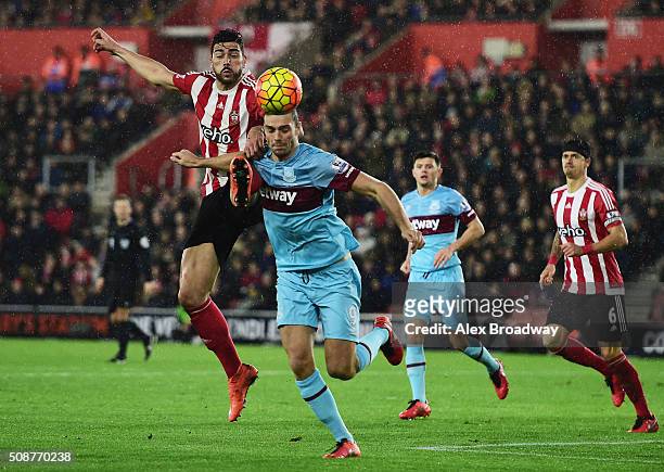 Graziano Pelle of Southampton challenges Andy Carroll of West Ham United during the Barclays Premier League match between Southampton and West Ham...