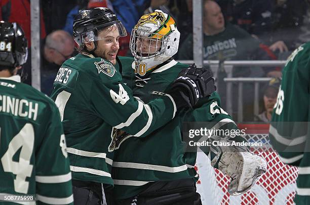 Jacob Graves of the London Knights congratulates teammate Brendan Burke on his shut-out against the Owen Sound Attack in an OHL game at Budweiser...