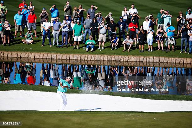 Bubba Watson takes his shot out of the bunker on the 15th hole during the third round of the Waste Management Phoenix Open at TPC Scottsdale on...