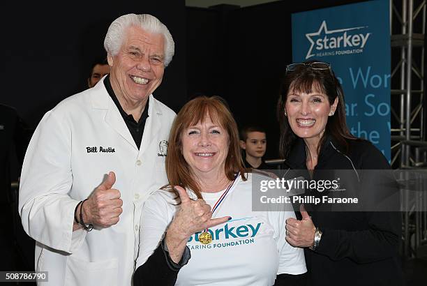 Starkey Hearing Foundation founder William F. Austin, Linda Daily, Au.D., and a patient give a thumbs up during the Starkey Hearing Foundation...