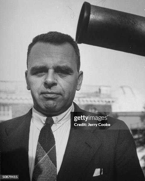 Dr. Astrologer Du Bart Jan Bok, standing next to his telescope.