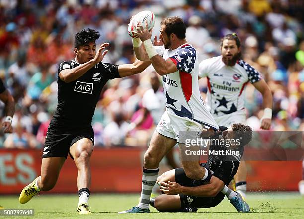 Zack Test of USA offloads the ball in a tackle during the 2016 Sydney Sevens Cup Quarter Final match between New Zealand and USA at Allianz Stadium...