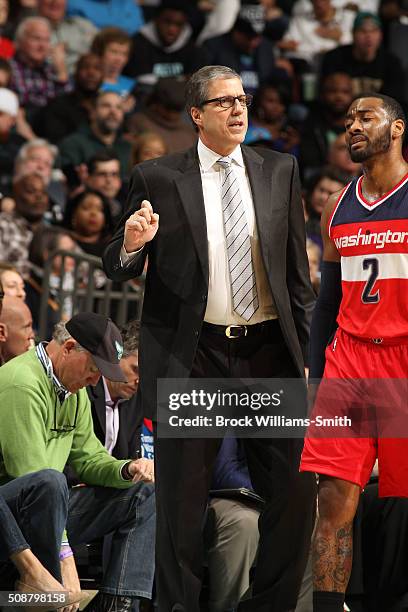 Randy Wittman, head coach of the Washington Wizards has a chat with John Wall of the Washington Wizards during the game against the Charlotte Hornets...