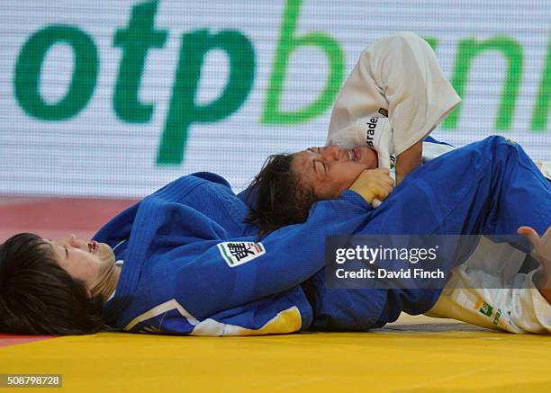 London Olympic champion, Sarah Menezes of Brazil resists a strangle attempt by Haruna Asami of Japan to eventually win the contest and the u48kg...