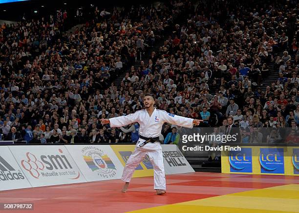 Walide Khyar of France happily dances around in front of the ten thousand, mainly French audience after winning the u60kg bronze medal during the...