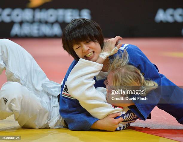 Former world champion, Haruna Asami of Japan holds Eva Csernoviczki of Hungary for an ippon to reach the u48kg semi-final during the 2016 Paris Judo...