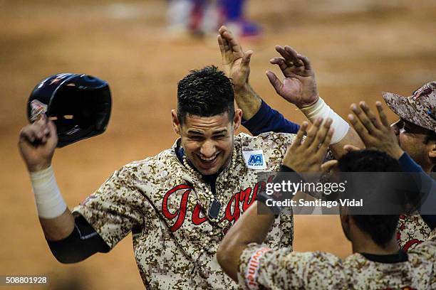 Dariel Alvarez of Tigres de Aragua celebrates with his teammates during the match between Cangrejos de Santurce of Puerto Rico and Tigres de Aragua...