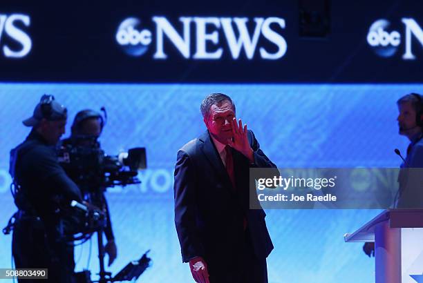 Republican presidential candidates Ohio Governor John Kasich talks to an audience member during a commercial break in the Republican presidential...