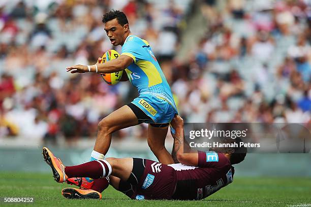 Feleti Mateo of the Manly-Warringah Sea Eagles tackles Matthew Srama of the Gold Coast Titans during the 2016 Auckland Nines quarter final match...